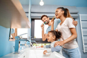 happy family brushing teeth at morning