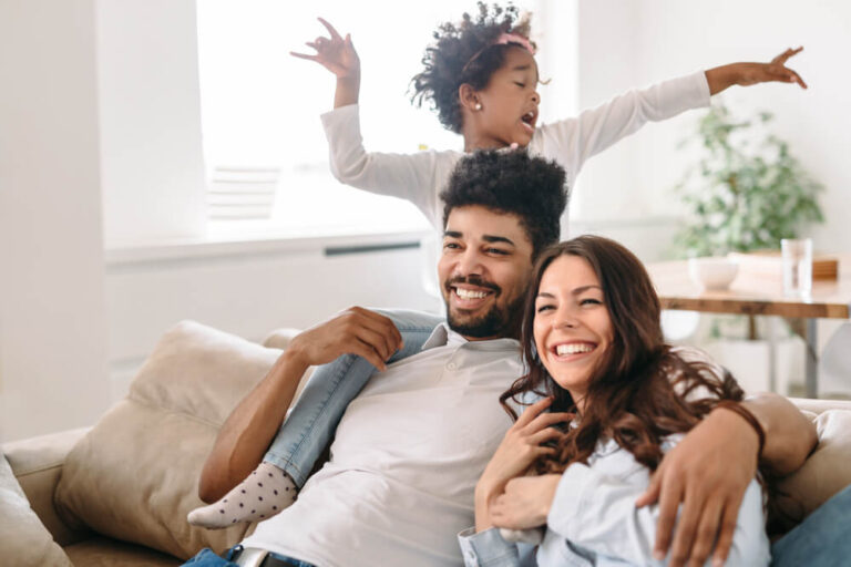Happy family of a mum and dad with their kid